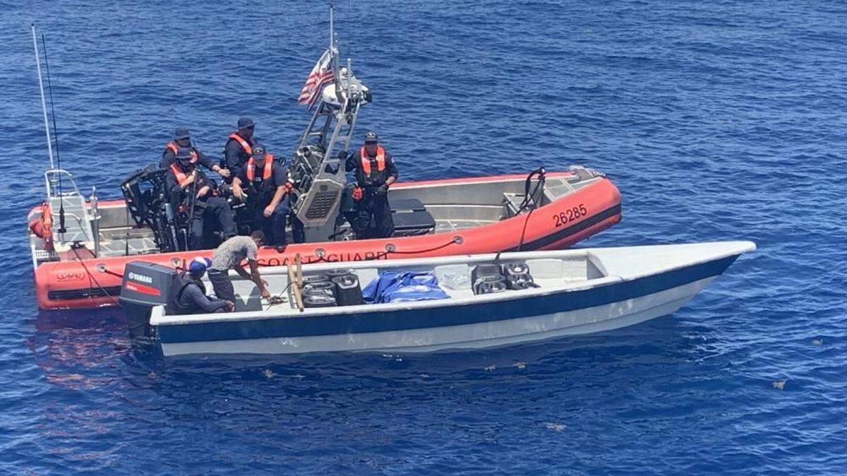 A U.S. Coast Guard patrol boat is pulled up along side a speedboat that the agency said was in the process of smuggling 250 kilograms of cocaine on Wednesday, Sept. 22, 2021.