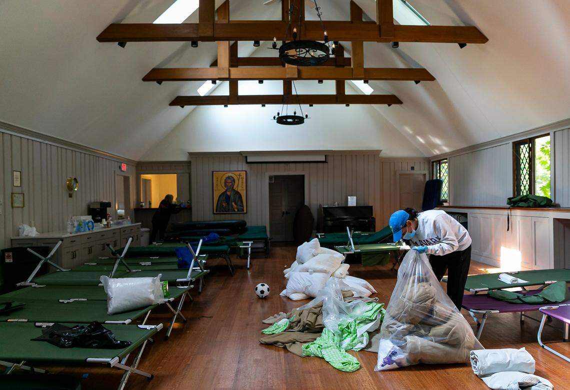 Katrina Lima, a volunteer, helps clean up the chapel area where a group of 48 migrants sheltered at St. Andrews Episcopal Church on Friday, Sept. 16, 2022, in Edgartown, Mass., on the island of Martha’s Vineyard.