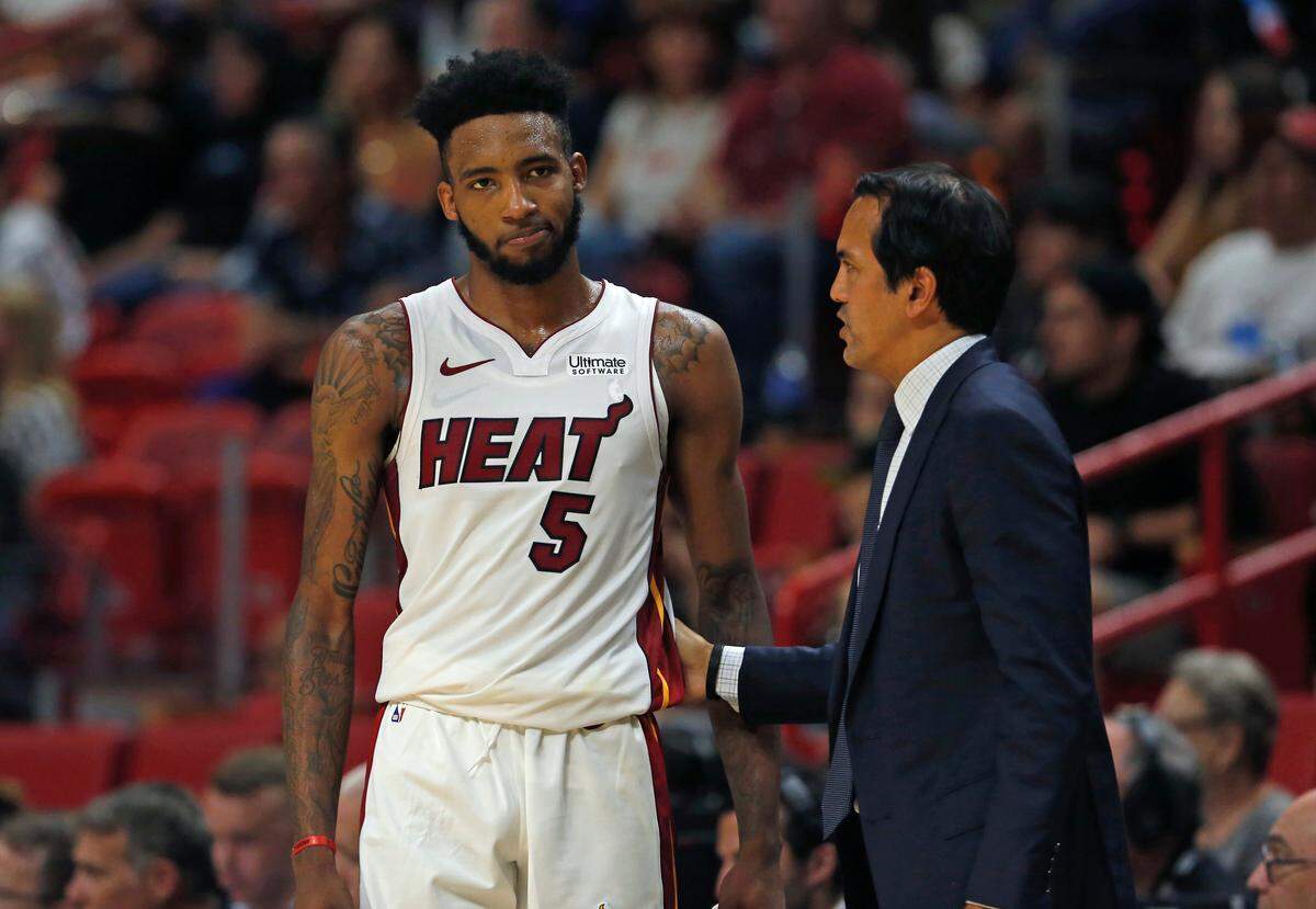 Heat head coach Erik Spoelstra talks with Derrick Jones Jr. (5) in the second quarter of an NBA basketball preseason game against the Rockets at the AmericanAirlines Arena on Oct. 18, 2019.