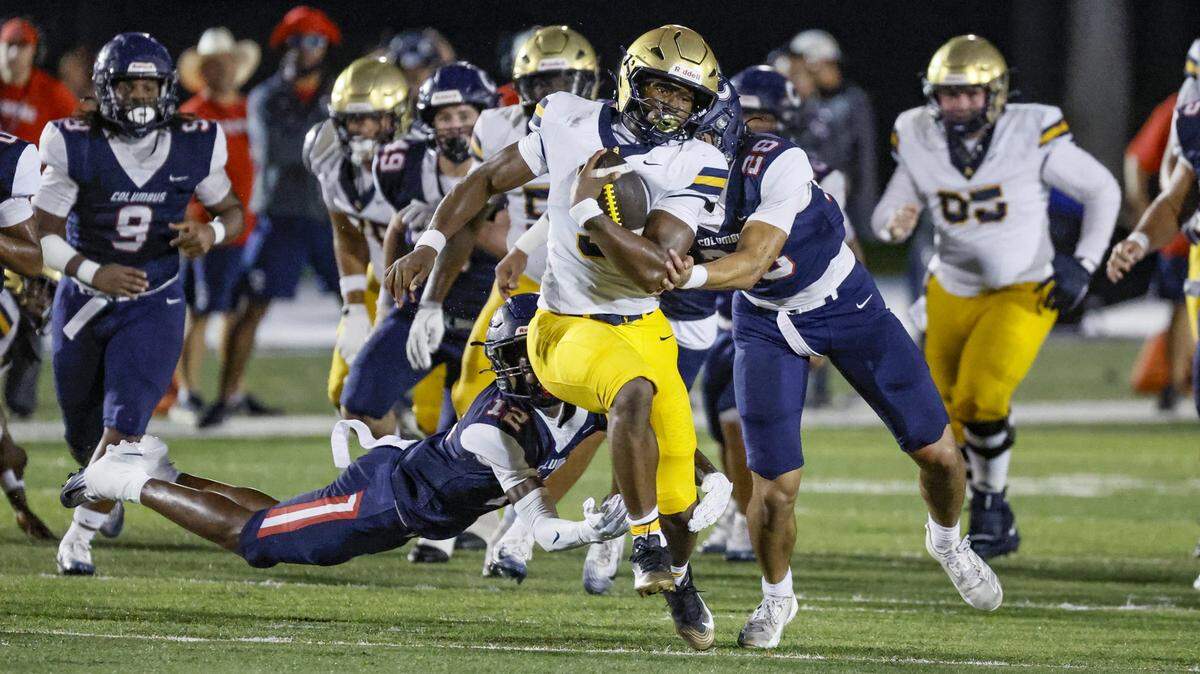 St. Thomas Aquinas running back Jaden Desir (3) breaks tackles attempted by Columbus Explorers defenders in the first half at Tropical Park Stadium in Miami, Florida, on Friday, September 5, 2025. 