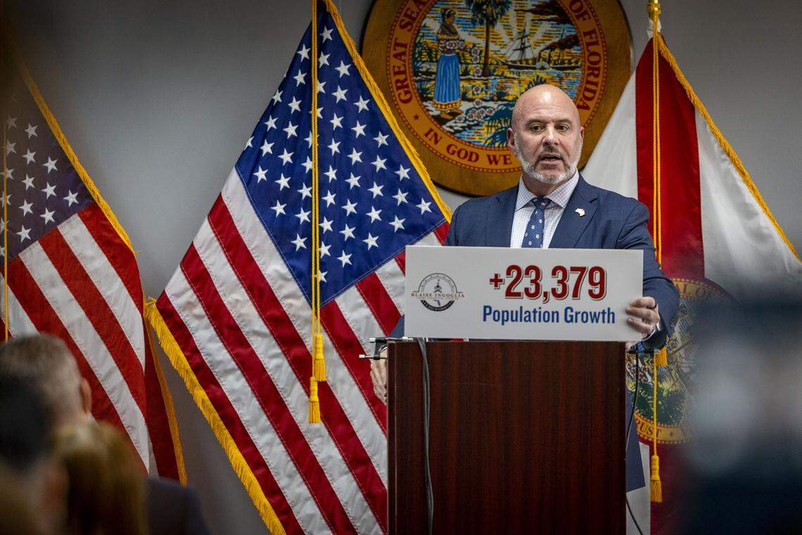 Florida Chief Financial Officer Blaise Ingoglia holds a sign showing the amount of population growth in the city of Miami over the last five years during a press conference at the Rohde Building in downtown Miami on Thursday, Oct. 23, 2025. 
