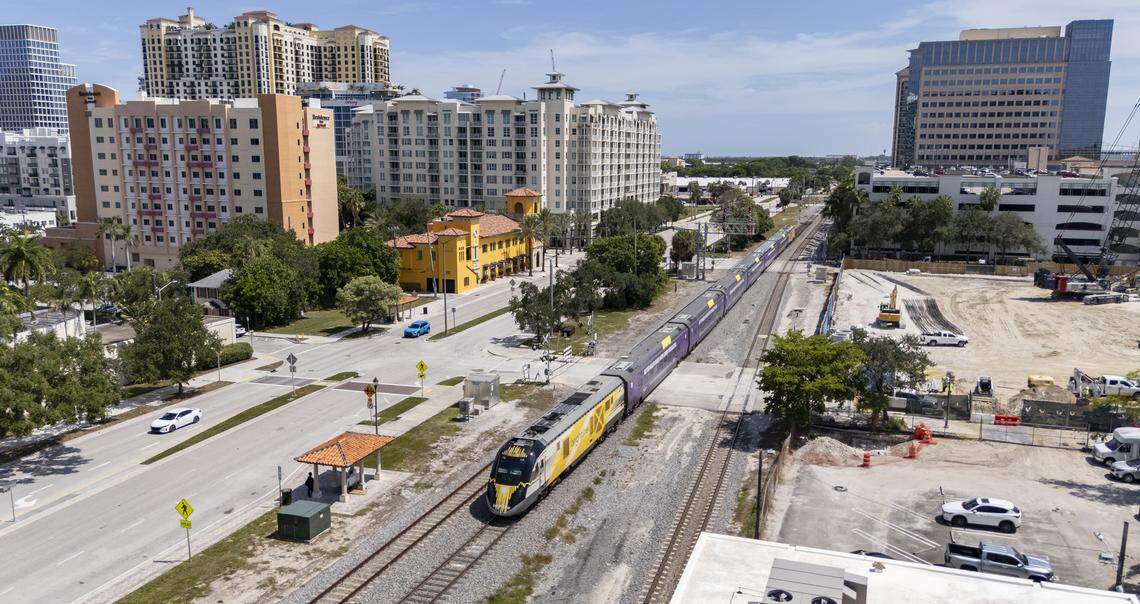 A Brightline train runs along open tracks in West Palm Beach after departing its station.