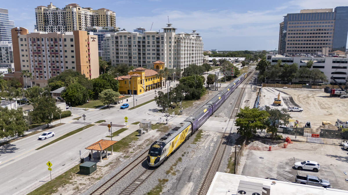 A Brightline train makes its way through West Palm Beach after departing its station on Thursday, July 31, 2025.