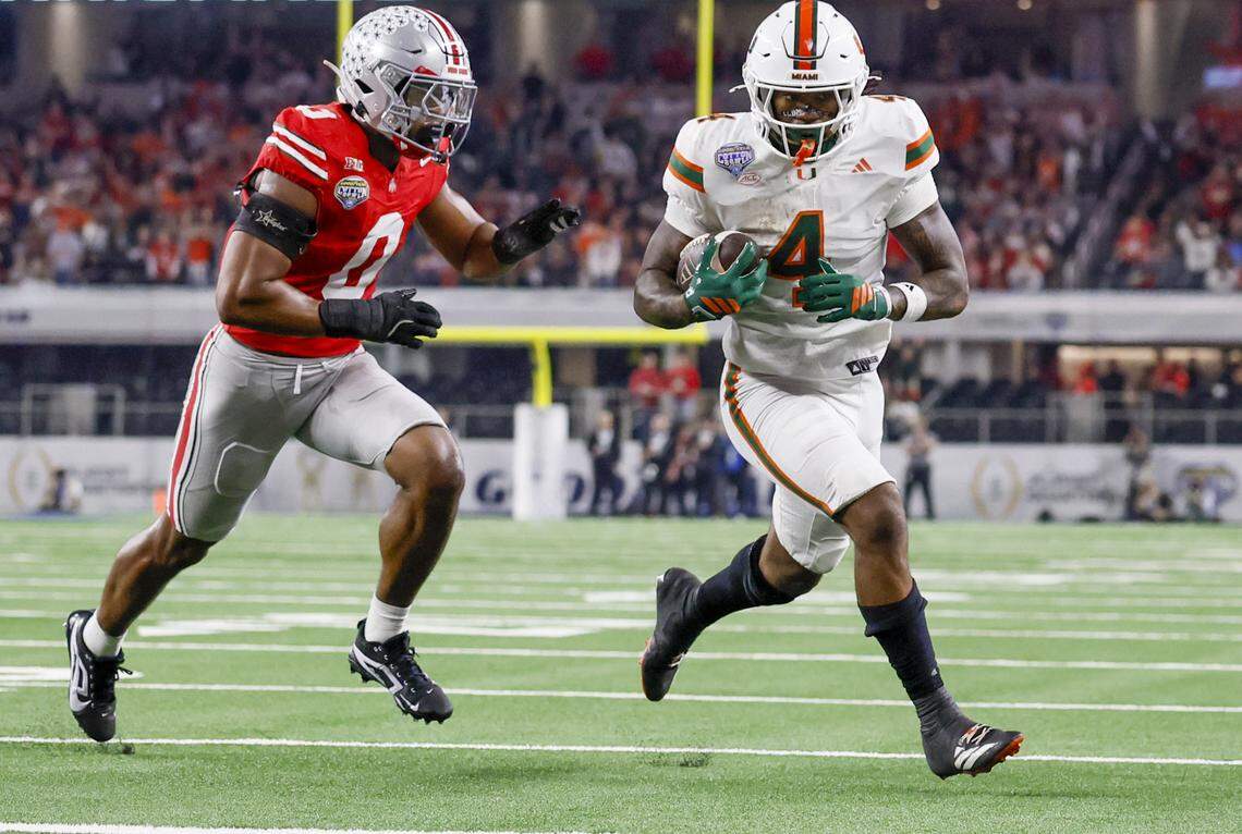 Miami Hurricanes running back Mark Fletcher Jr. (4) runs to score as Ohio State Buckeyes linebacker Sonny Styles (0) defends during the first half of the College Football Playoff quarterfinal game in the Cotton Bowl at AT&T Stadium in Arlington, Texas on Wednesday, December 31, 2025.