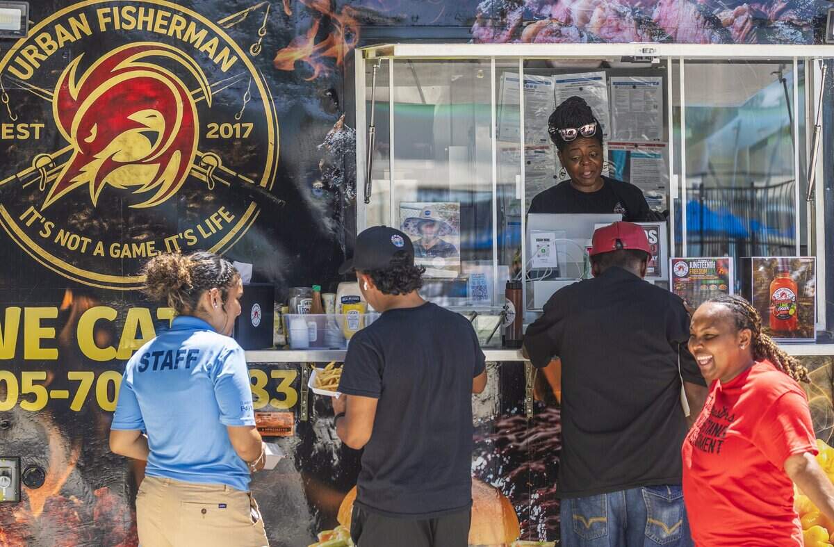 Long time Coconut Grove residents Tiffany Bell, owner of the Urban Fisherman food truck takes care of patrons during the 3rd Annual Juneteenth Freedom Day Emancipation celebration at the Elizabeth Virrick Park, that featured live music, cultural performances, storytelling, and community fellowship, on Friday June 19, 2026.