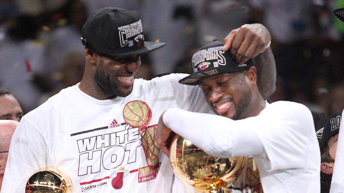 LeBron James and Dwyane Wade celebrate with both trophies after the Heat won Game 7 of the 2013 NBA Finals at AmericanAirlines Arena in Miami, Florida on Thursday, June 20, 2013.