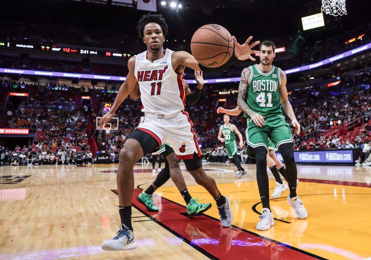 Miami Heat forward KZ Okpala (11) chases a lose ball against the Boston Celtics in the fourth quarter at the FTX Arena in Miami on Friday, October 15, 2021.