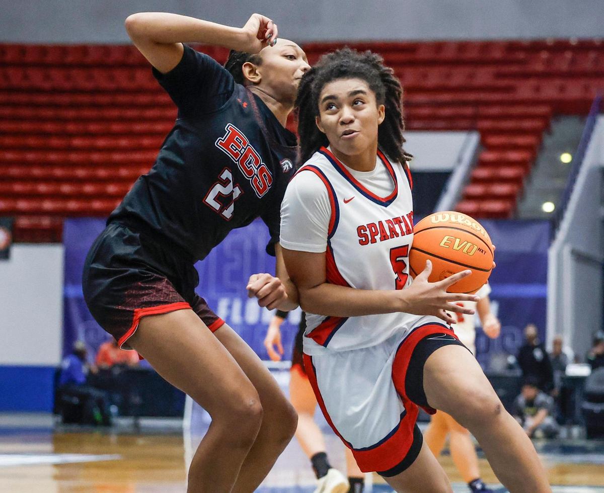 Miami Country Day’s Kamie Ellis (5) drives to the basket as Evangelical Christian’s Nalah Smith (21) defends in the second half during girls basketball state semifinal of the Florida High School State Championships at the RP Funding in Lakeland, Florida on Thursday, February 27, 2025.