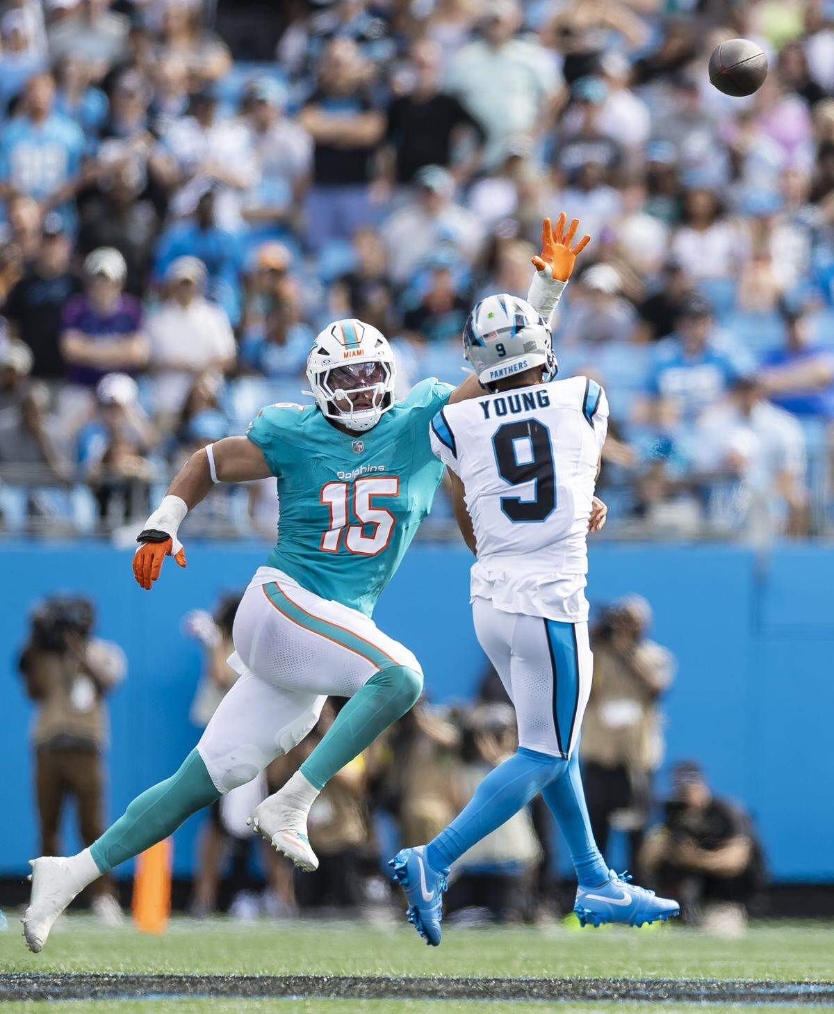 Miami Dolphins linebacker Jaelan Phillips (15) tries to stop Carolina Panthers quarterback Bryce Young (9) from scoring in the second half of their NFL game at the Bank of America Stadium on Sunday, Oct. 5, 2025, in Charlotte, N.C.