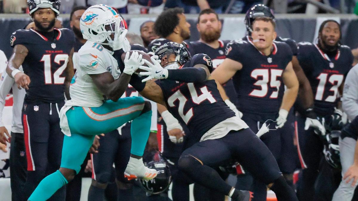 Houston Texans cornerback Derek Stingley Jr. (24) strips the ball from Miami Dolphins wide receiver Tyreek Hill (10) on a pass reception late in the second half of their NFL football game at NRG Stadium in Houston, Texas, on Sunday, December 15, 2024.