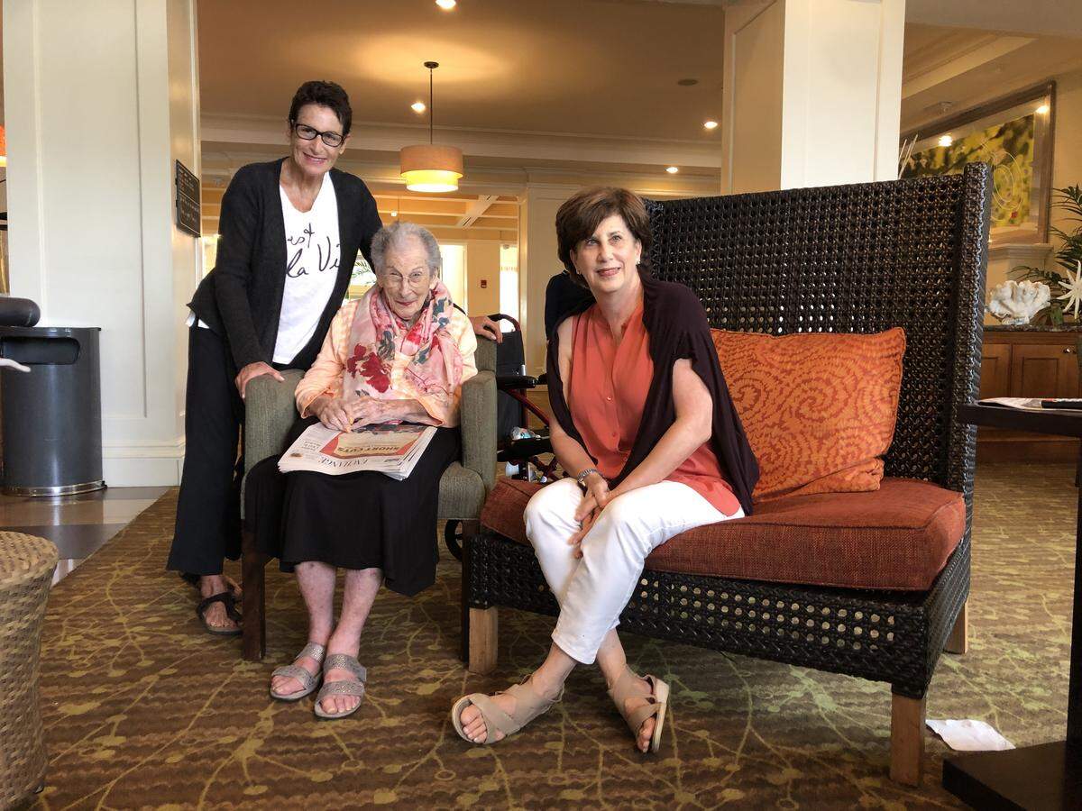 Sharon Robbins, 102, poses with her daughters Phyllis Frydman (left) and Jodi Rosen (right) in the common room of the Hilton Garden Inn in Palm Beach Gardens on Monday, Sept. 2. The family has been there since evacuating their homes Saturday.