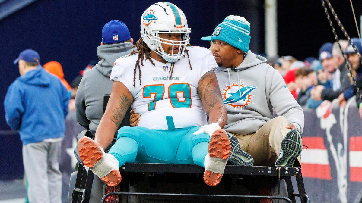 Miami Dolphins offensive tackle Kendall Lamm (70) is carted off the field after getting injured in a play during second quarter of NFL football game against the New England Patriots at Gillette Stadium on Sunday, January 1, 2023 in Foxborough, MA.