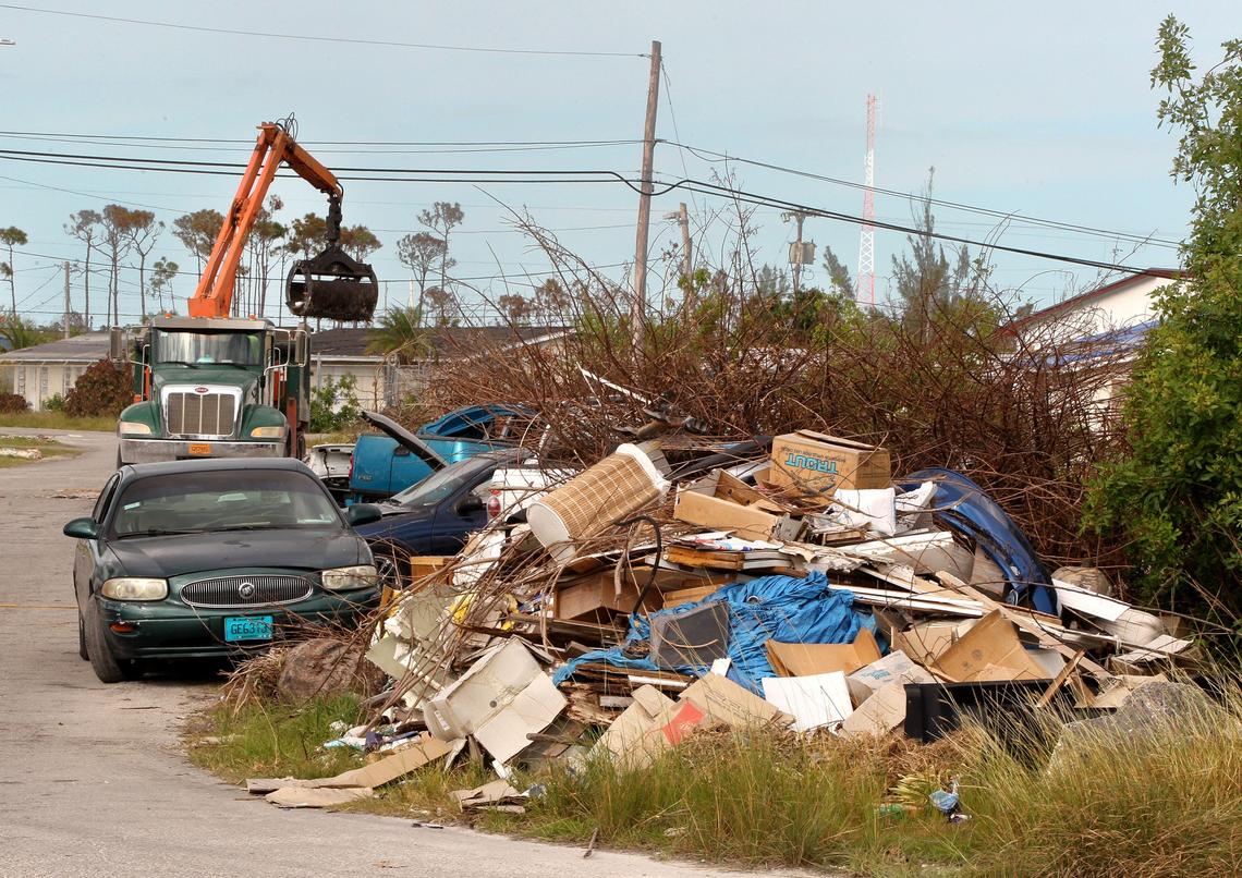 A cleaning crew works at a Freeport neighborhood on Nov. 23, 2019, as the island’s residents still struggle after Hurricane Dorian, the most intense tropical cyclone on record to strike the Bahamas. Dorian hit the northwestern Bahamas as a Category 5 hurricane in early September.