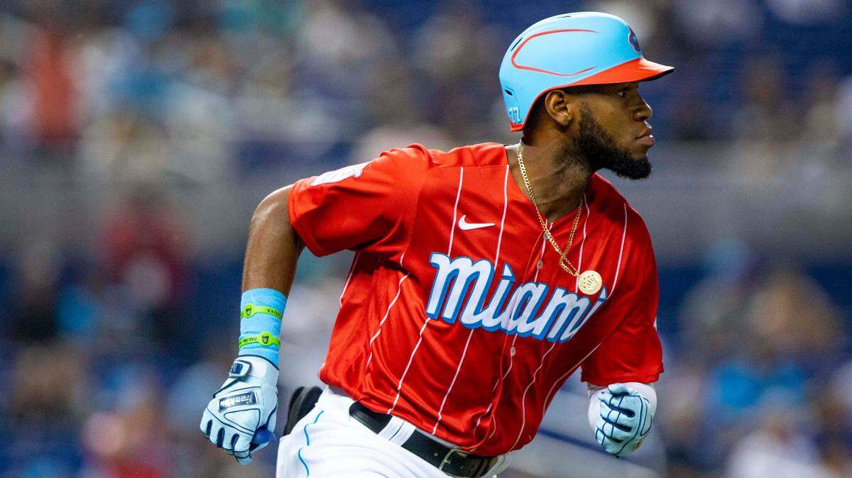 Miami Marlins base runner Bryan De La Cruz (77) runs toward first base after hitting a single during the seventh inning of an MLB game against the Chicago Cubs at loanDepot park in the Little Havana neighborhood of Miami, Florida, on Saturday, August 14, 2021.