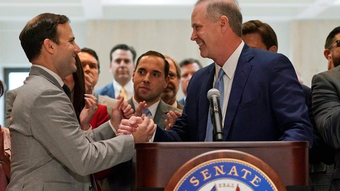 Speaker of the House Chris Sprowls, left, and Senate President Wilton Simpson shake hands as they celebrate the end of a legislative session, Friday, April 30, 2021, at the Capitol in Tallahassee, Fla.