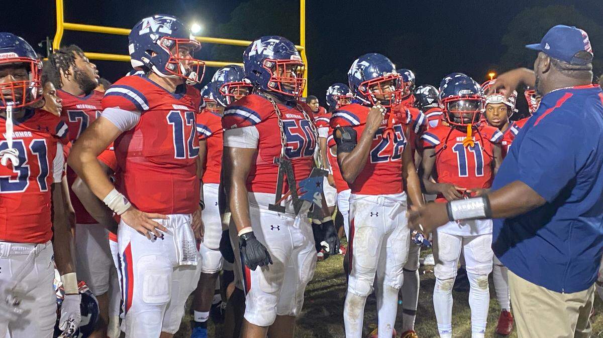 Miramar coach A.J. Scott (right) speaks to his team after it handled Miami Belen Jesuit for a 31-7 win in a Region 4-3M semifinal at the Patriots’ home field.