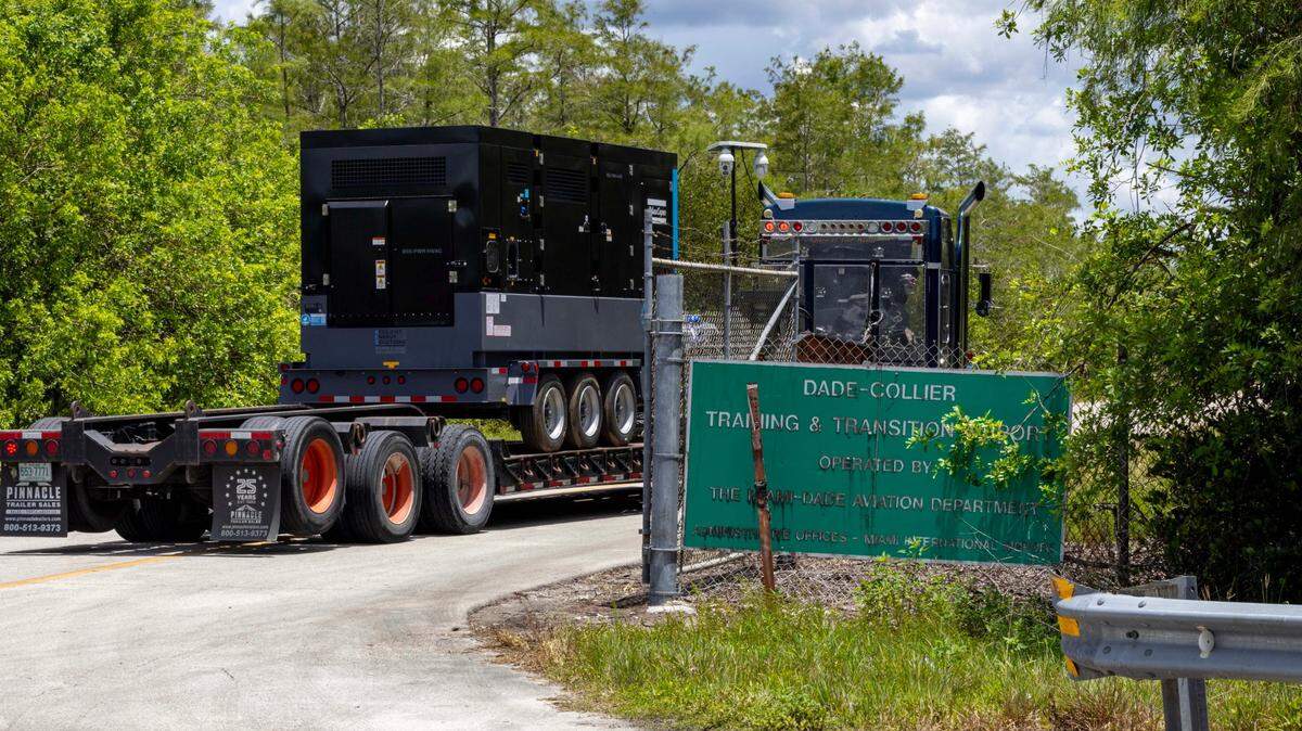 A truck transports heavy generators into Dade-Collier Training and Transition Airport off Tamiami Trail on Monday, June 24, 2025, in Ochopee, Fla., about a week before Alligator Alcatraz opened on the site. 