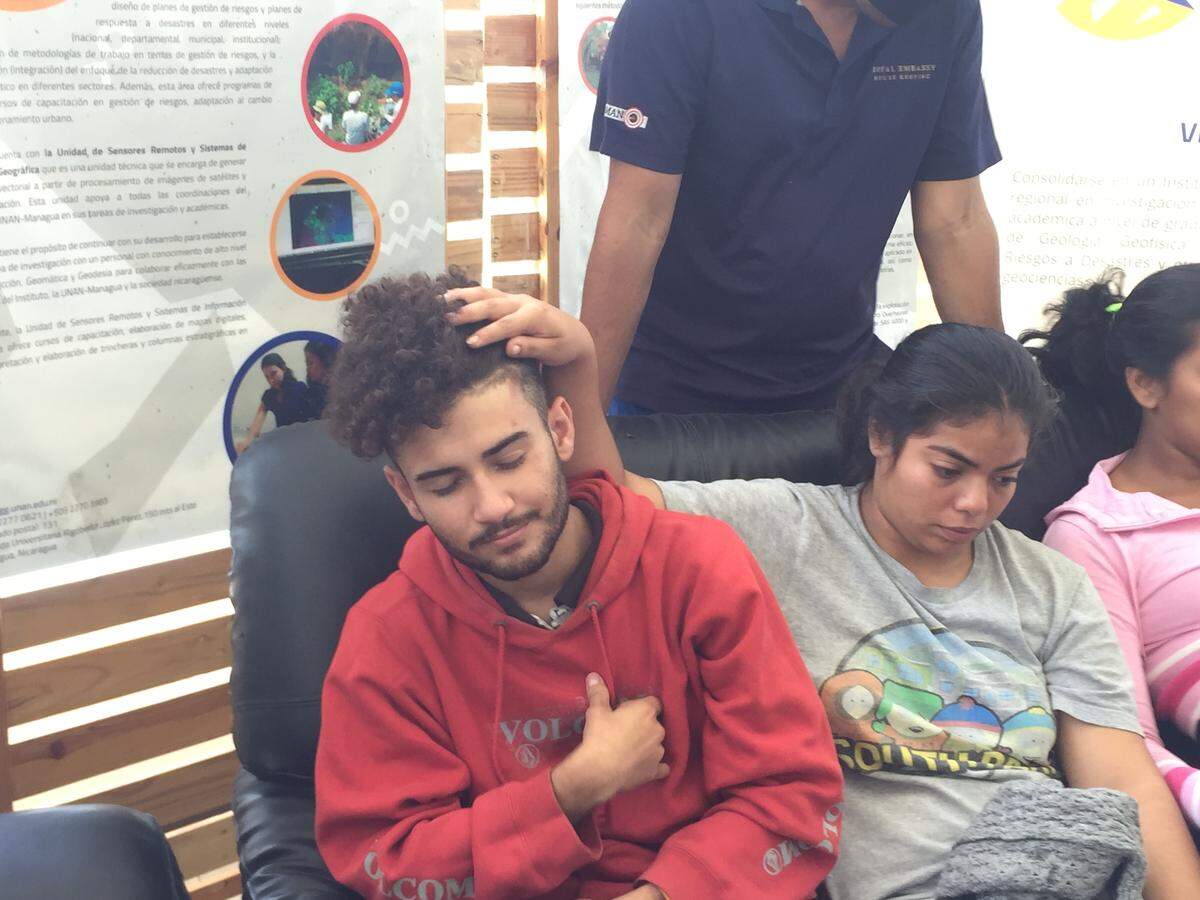 University student Valeska Sandoval pulls back her classmate Byron Miranda's hair to show bruises from armed men who kidnapped the students and tortured them for hours on the night of June 4, 2018. The next morning, the students recounted the kidnapping at the National Autonomous University of Nicaragua, where students had taken over the campus.