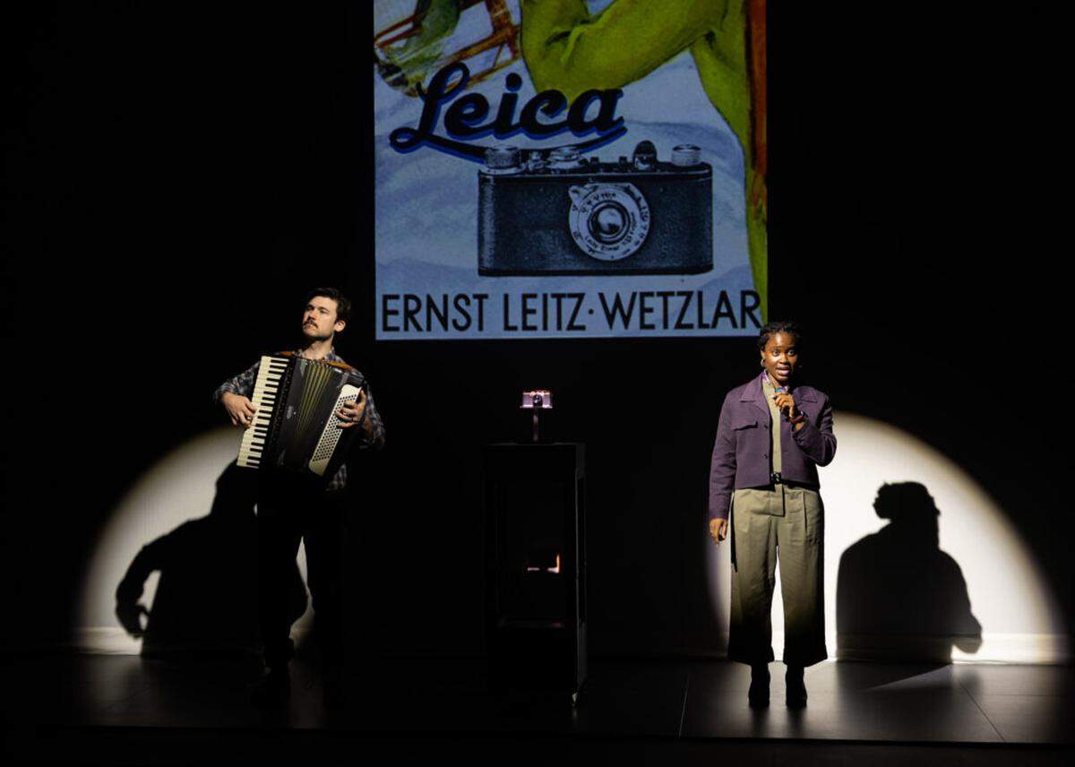 An accordion player (Marrick Smith) accompanies an expert (Folami Williams) as she talks about the pursuit of happiness of the Leica camera in “Here There Are Blueberries.”