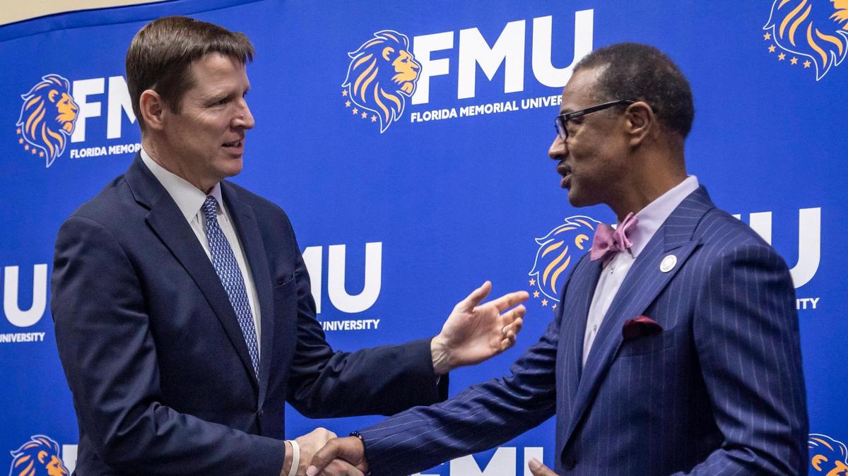 Tim Berry, Global Head of Corporate Responsibility and Chairman of the Mid-Atlantic Region, JPMorgan Chase, left, shakes hands with Dr. Jaffus Hardrick, President of Florida Memorial University after Tim Berry announced a $1 million donation to FMU from JPMorgan Chase during a small ceremony at FMU in North West Miami Dade.