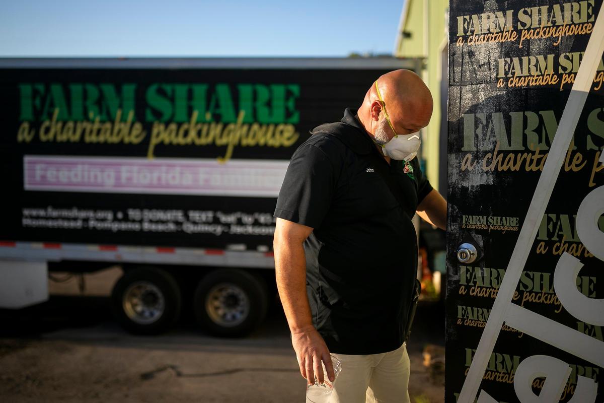 John Delgado, 52, the assistant operations manager at Farm Share, leaves for the day from the company’s warehouse in Homestead. He works late to soak in the air conditioning in his office before going back to his backyard tent.