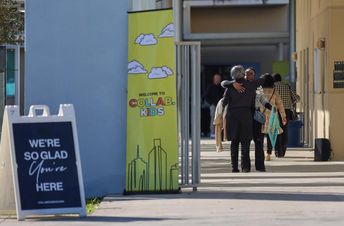 Greeter Carline Larson welcomes worshipers to Sunday service on January 21, 2024, in Miami Gardens, Florida. The Assemblies of God church sold its eight-acre property to developers in 2022, and the church rebranded to Collab.Church the same year at operates temporarily inside the auditorium of the North Dade Middle School.