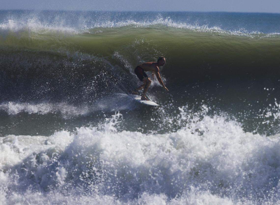 Tyler Walker surfs during the morning on Thursday, Aug. 21, 2025, off the beach in Stuart, Fla. Surfers estimated that waves ranged from 8 - 12 feet all morning.