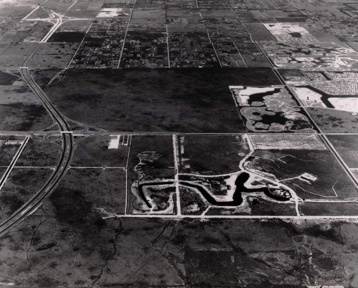 A 1983 aerial photo of Century Village in Pembroke Pines under construction at lower half of picture. I-75 swings through the photo at left. Hollywood Boulevard cuts across the center from right to left. C.B. Smith Park is visible at right north of Hollywood Boulevard.