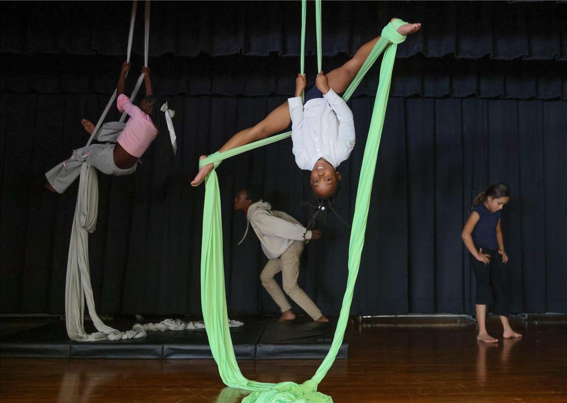 Melanie Almon, 8, works on her form while practicing on the aerial silks during the after school program at Miami Shores Elementary. Nakia Bowling, with Ten North Group, founded the after school program which focuses on enrichment through photography, aerial activities, dance, and art.