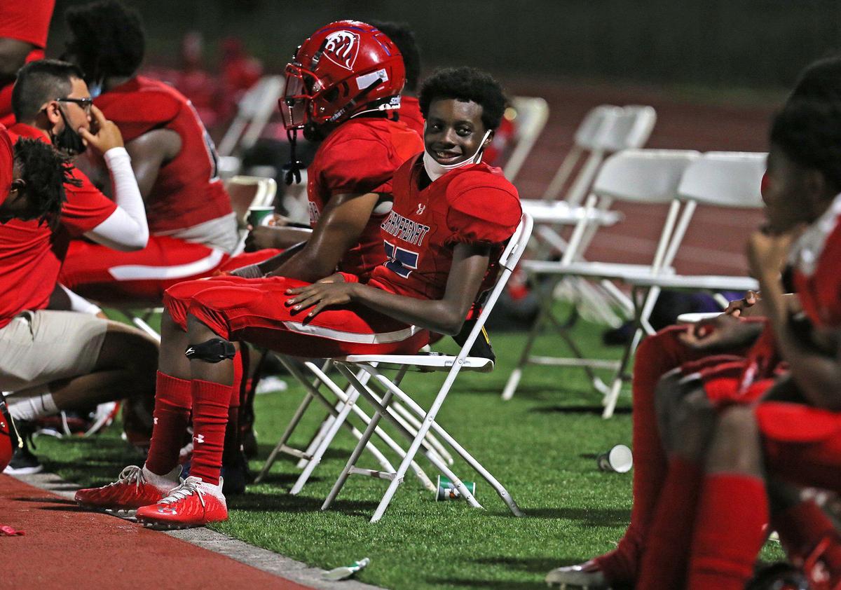 Champagnat Catholic players sit in chairs on the sideline as they play Chaminade-Madonna at Chaminade-Madonna College Preparatory School, Hollywood, Florida, Friday, September 11, 2020.