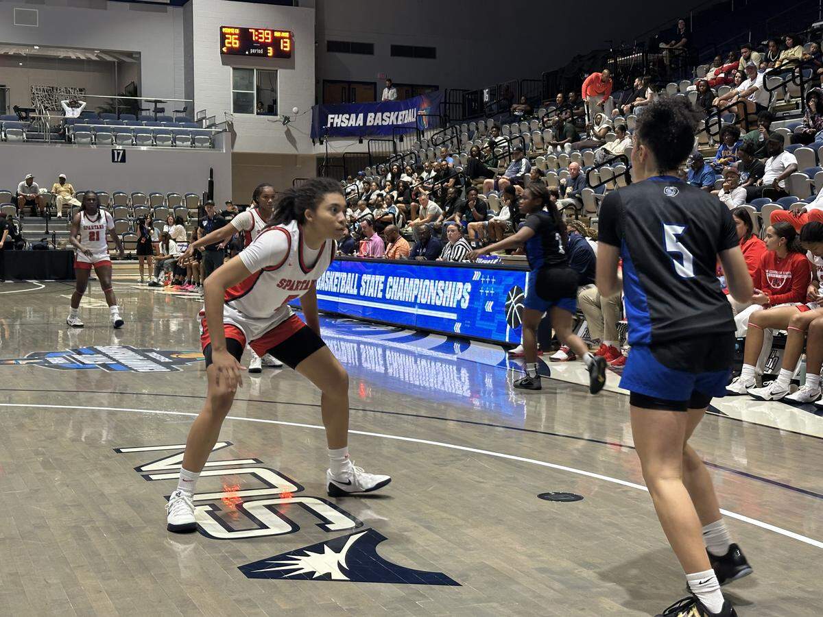 Miami Country Day’s Kamie Ellis (left) defends San Jose Prep’s Lena Most (right) during Friday’s Class 2A girls’ basketball state semifinal at UNF Arena in Jacksonville, Fla.