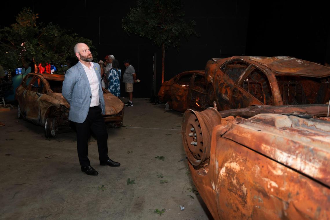 Rabbi Jonathan Fisch of Temple Judea in Coral Gables watches a video as he stands surrounded by destroyed vehicles at the Nova Exhibition Miami at Greenwich Studios in North Miami, Florida, on Thursday, December 19, 2024. The Nova Exhibition is an in-depth remembrance of the terrorist attacks by Hamas at The Nova Music Festival on October 7th of last year.