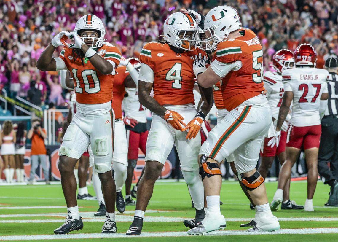 Miami Hurricanes running back Mark Fletcher Jr. (4) celebrates with teammates after scoring in the first quarter against the Louisville Cardinals during their NCAA football game at Hard Rock Stadium in Miami Gardens, Florida, on Friday, October 17, 2025.