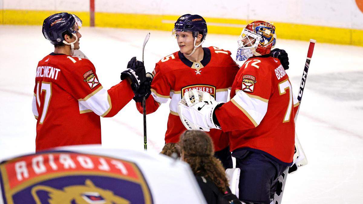 Florida Panthers players Mason Marchment (17) Anton Lundell (15) and Sergei Bobrovsky (72) celebrate their 4-1 win over the Colorado Avalanche during an NHL game at the FLA Live Arena on Thursday, October 21, 2021 in Sunrise, Fl.