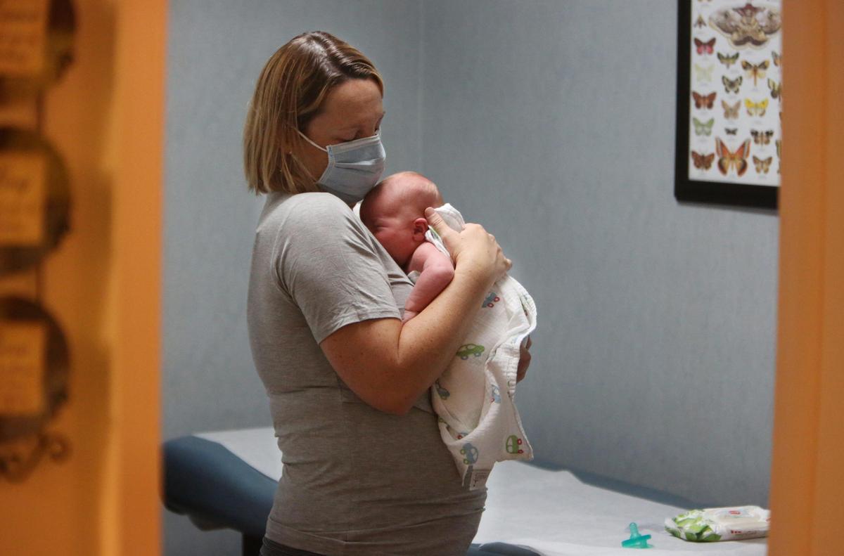 Shauna Casey comforts her 12-day-old son, Lane, during Lane’s very first scheduled newborn checkup on April 7, 2020.