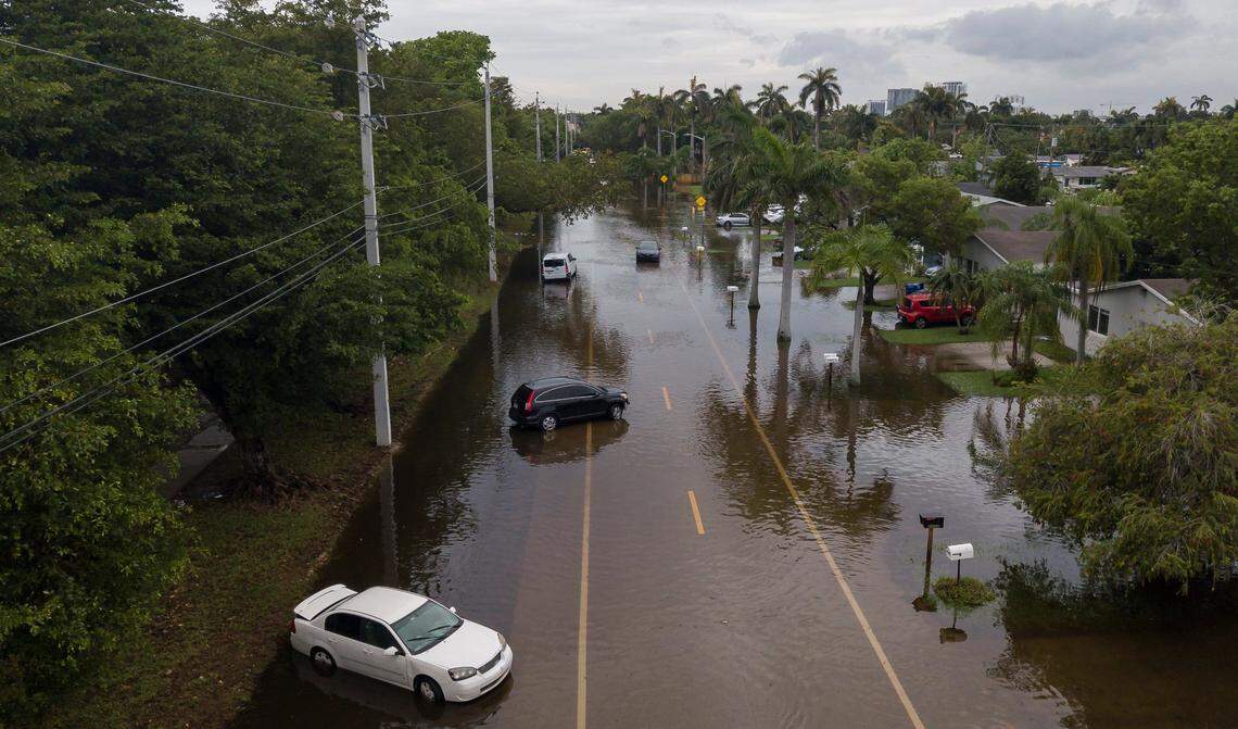 Abandoned cars sit on a flooded North 14th Avenue on Thursday, June 13, 2024, in Hollywood, Florida. Residents in Hollywood woke up to flooded streets and debris after Wednesday’s storm left their community inundated by heavy rain.