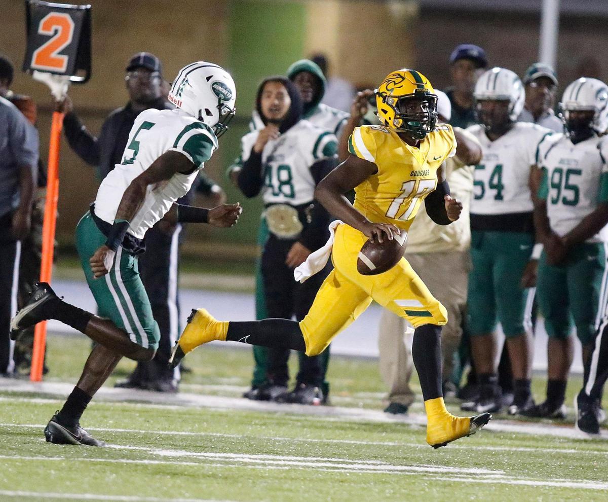 Killian Cougars quarterback Khalil Anglin (17) gains yardage against Miami Central Rockets during the FHSAA Region 4-5A high school football championship on Saturday, November 27, 2021 at Tropical Park in Miami. Andrew Uloza / for THE MIAMI HERALD