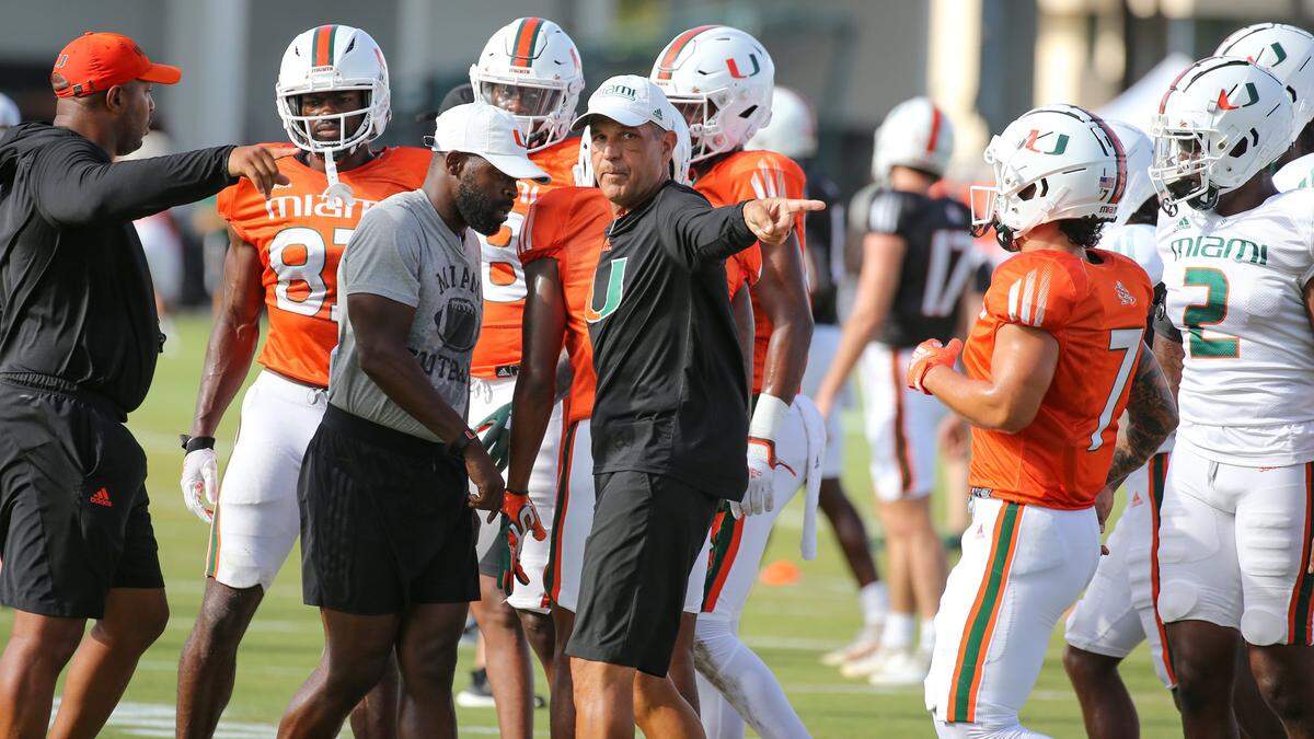 Miami Hurricanes Defensive Coordinator Kevin Steele, at center, works with players during practice drills at Greentree Practice Field at the University of Miami in Coral Gables on Thursday, August 11, 2022.