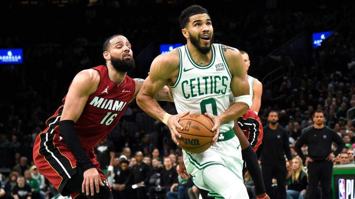 Boston Celtics forward Jayson Tatum (0) drives to the basket past Miami Heat forward Caleb Martin (16) during the second half in game one of the first round for the 2024 NBA playoffs at TD Garden.