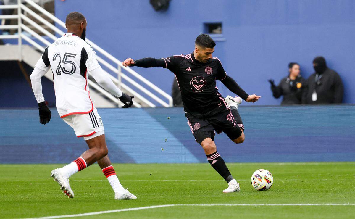 Jan 22, 2024; Dallas, TX, USA; Inter Miami forward Luis Suarez (9) shoots as FC Dallas defender Sebastien Ibeagha (25) defends during the first half at Cotton Bowl Stadium. Mandatory Credit: Kevin Jairaj-USA TODAY Sports