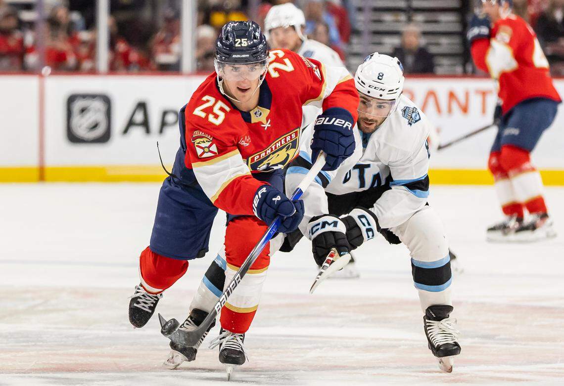 Florida Panthers right wing Mackie Samoskevich (25) skates with the puck as Utah Hockey Club center Nick Schmaltz (8) defends in the first period of their NHL game at Amerant Bank Arena on Friday, March 28, 2025, in Sunrise, Fla.