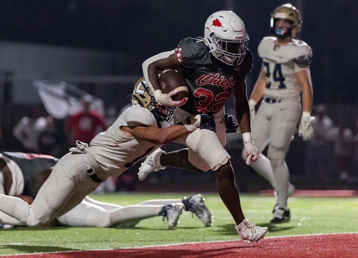 Cardinal Gibbons Chiefs running back Donte Findeson (32) scores a touchdown against the Calvary Christian Academy Eagles at Cardinal Gibbons High School on Friday, Sept. 27, 2024, in Fort Lauderdale, Fla.