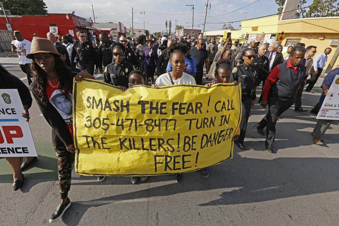 Community members, police and public officials held a peace walk in Liberty Square in Miami on Wednesday after a recent shooting that killed two young men and wounded two more.