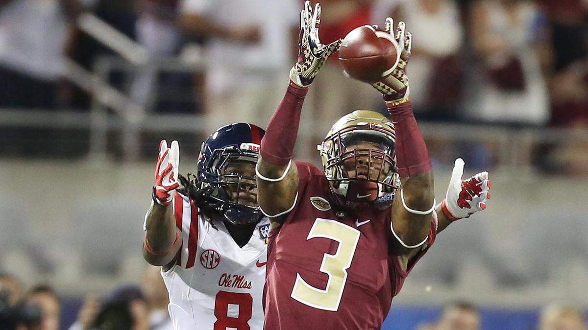 FSU defensive back Derwin James (3) intercepts a pass intended for Ole Miss receiver Quincy Adeboyejo (8) during the Florida State versus University of Mississippi college football game at Camping World Stadium in Orlando on Monday, September 5, 2016.