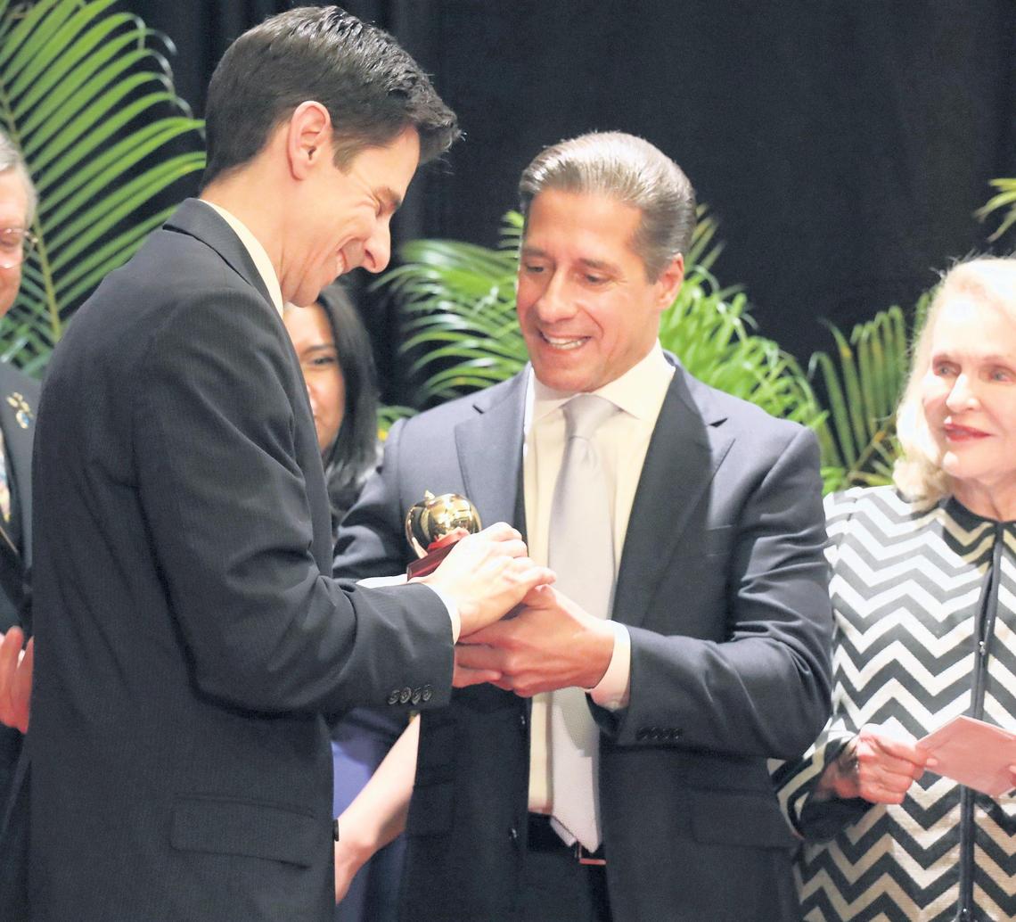Oliver Diez, a music teacher at Palmetto Elementary, left, smiles as Miami-Dade Schools Superintendent Alberto M. Carvalho, gives him the 2020 Francisco R. Walker Miami-Dade County Teacher of the Year award on Thursday, Jan. 31, 2019, at the DoubleTree by Hilton Miami Airport Convention Center in Miami.