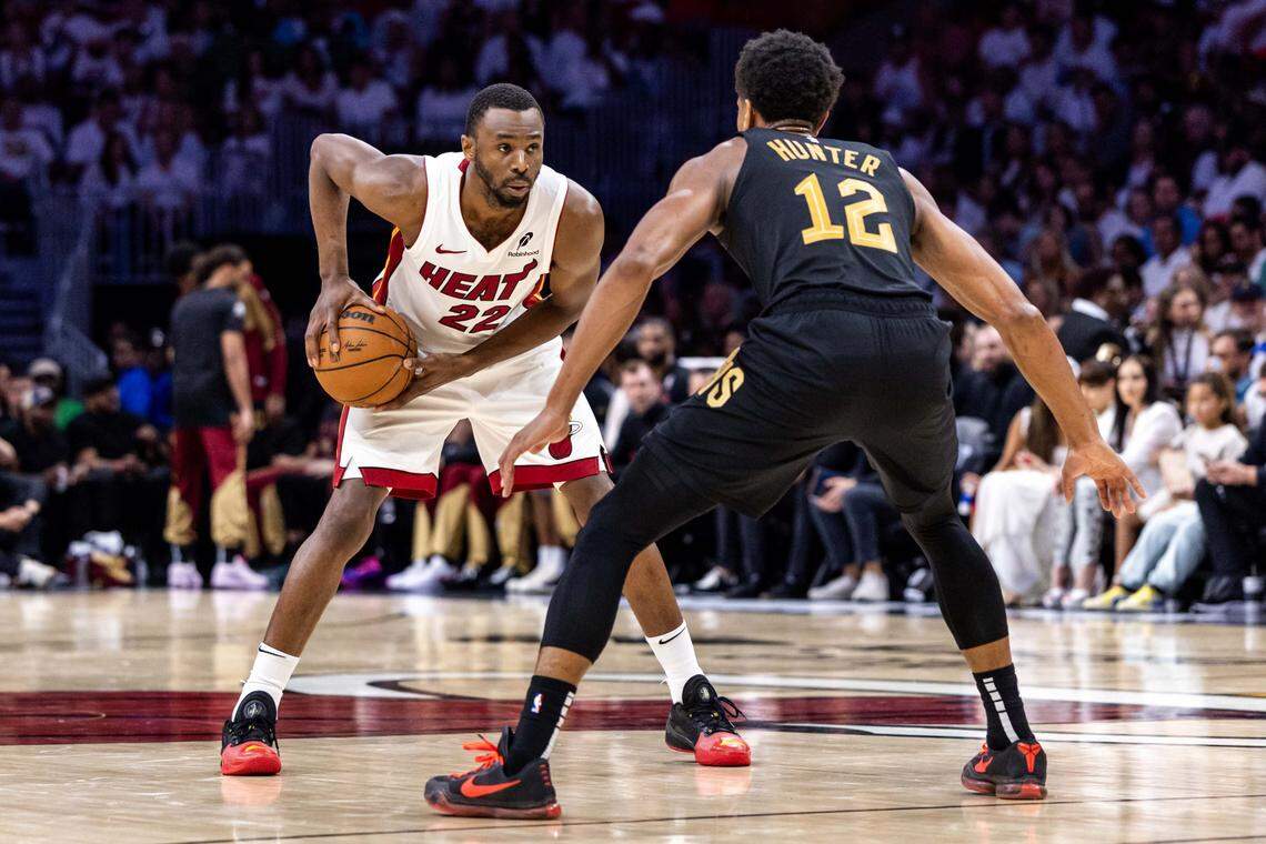 Miami Heat forward Andrew Wiggins (22) holds the bal while defended by Cleveland Cavaliers forward De'Andre Hunter (12) during the second half of Game 3 of the NBA Playoffs at Kaseya Center on April 26, 2025, in Miami.