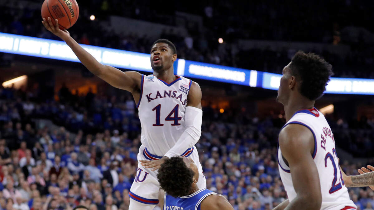 Kansas’ Malik Newman (14) is fouled on his way to the basket by Duke’s Wendell Carter Jr (34) during overtime of a regional final game in the NCAA men’s college basketball tournament Sunday, March 25, 2018, in Omaha, Neb. Newman has agreed to a deal with the Miami Heat.