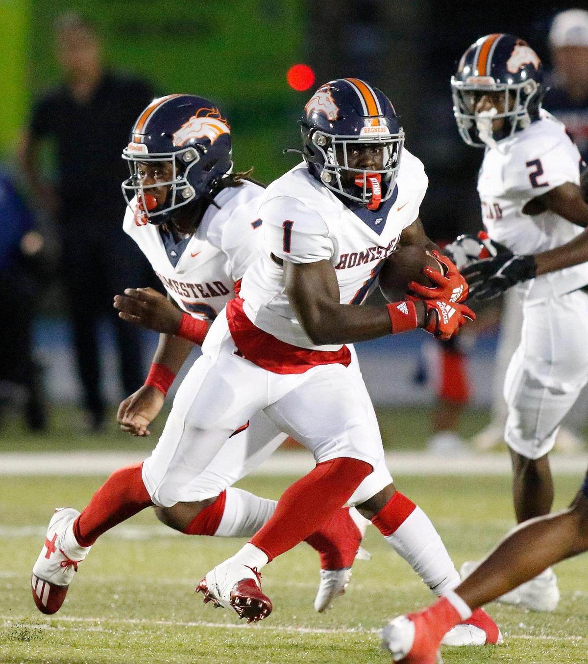 Homestead Broncos running back Isaac Brown (1) carries the ball against Columbus Explorers during the football game on Saturday, October 07, 2023 at Tropical Park Stadium in Miami. Andrew Uloza / for Miami Herald