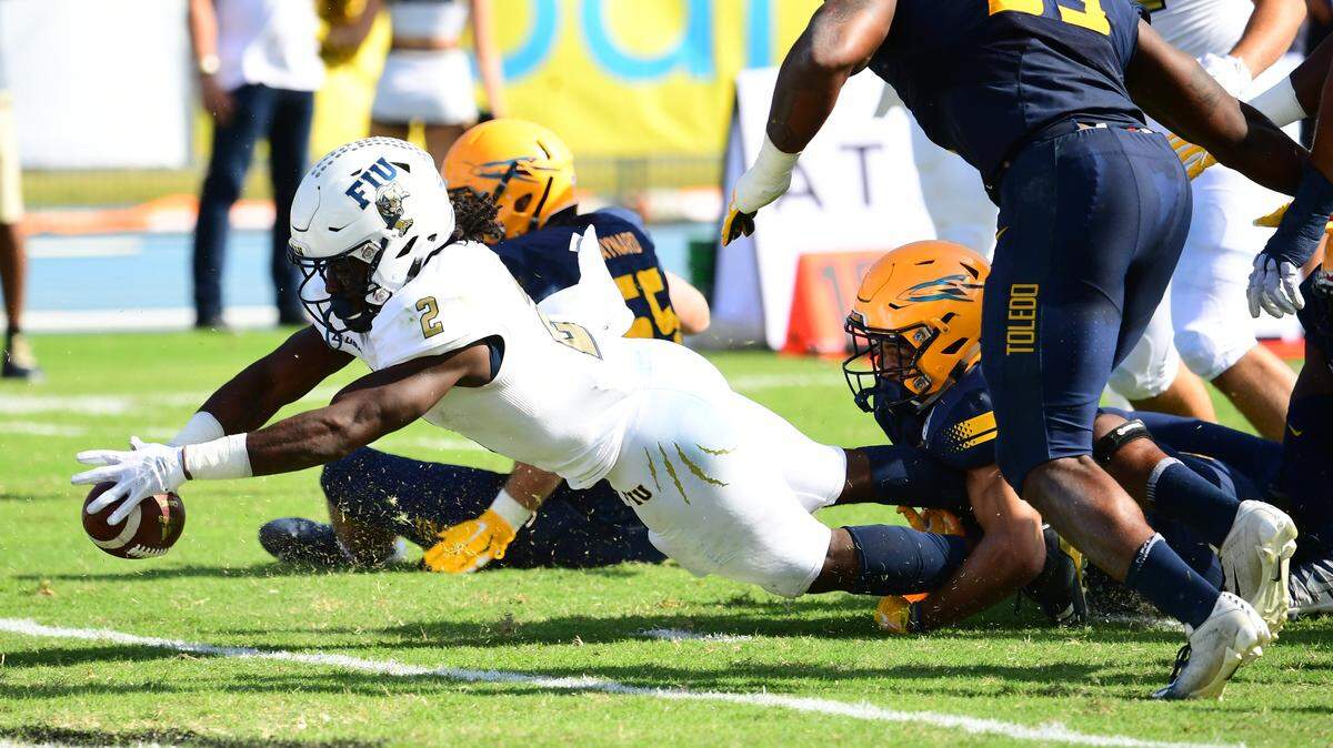 FIU running back Anthony Jones (2) crosses the goal line with the first of his three touchdown runs in the first quarter of the Panthers’ 35-32 victory over Toledo during the 2018 Makers Wanted Bahamas Bowl at Thomas A. Robinson National Stadium in Nassau, Bahamas