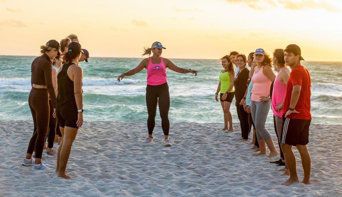 Certified personal trainer Kristen Smith leads a fitness class at sunrise on Tuesday, Jan. 23, 2024, as part of her Miami Beach Fit Camp. She used to weigh 405 pounds and has lost more than 240 pounds since 2006. She will run her first Life Time Miami Marathon on Sunday, Jan. 28th.